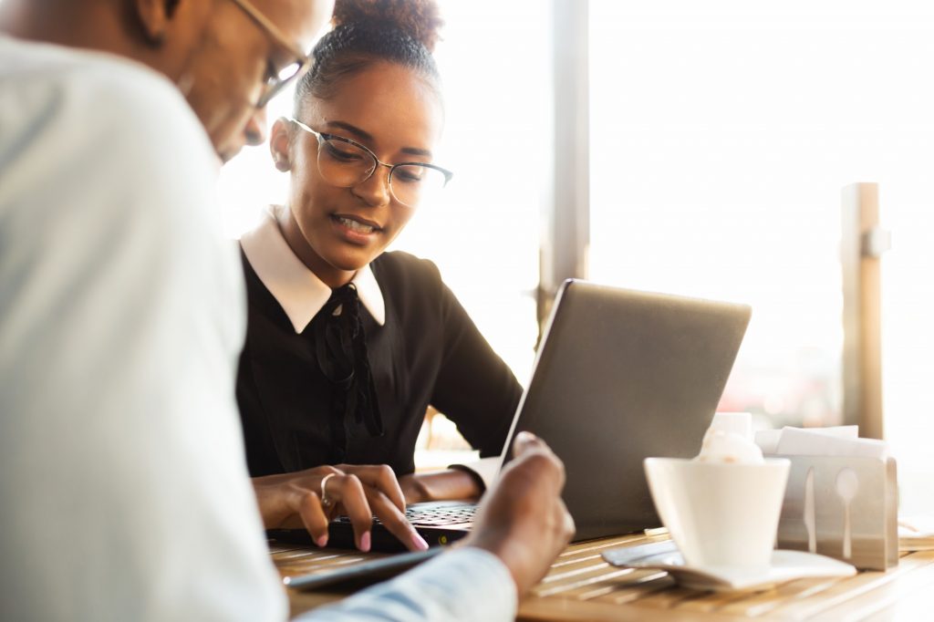 Black African American coworkers doing digital teamwork arround